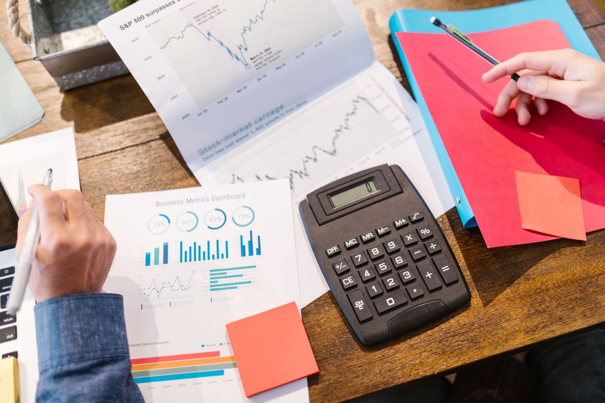 Business planning documents, financial charts and calculator